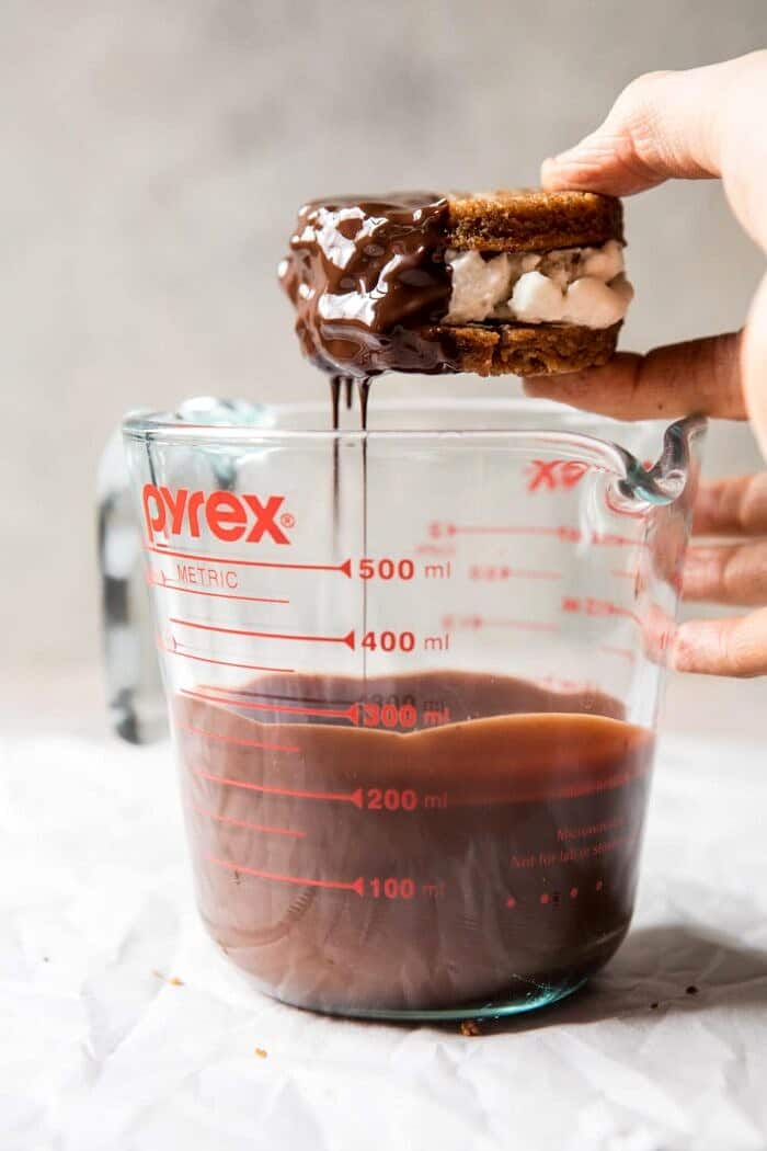 dipping the Chocolate Dipped Peanut Cookie Ice Cream Sandwiches in chocolate 