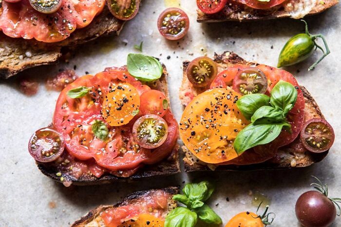 horizontal photo of Heirloom Tomato, Basil, and Manchego Toast