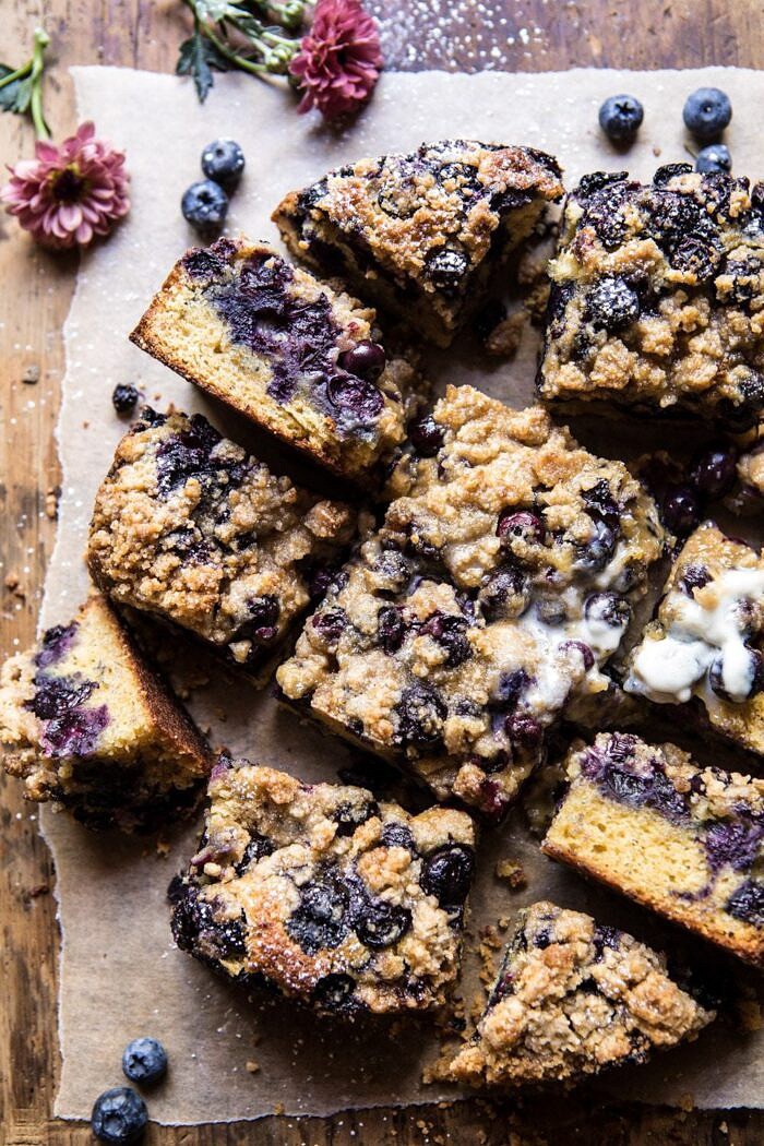 overhead photo of Bursting Blueberry Cardamom Buckle with flowers in photo