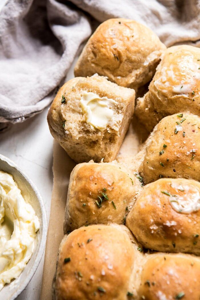 side angle photo of Buttery Pull Apart Whole Wheat Potato Rolls with butter on roll