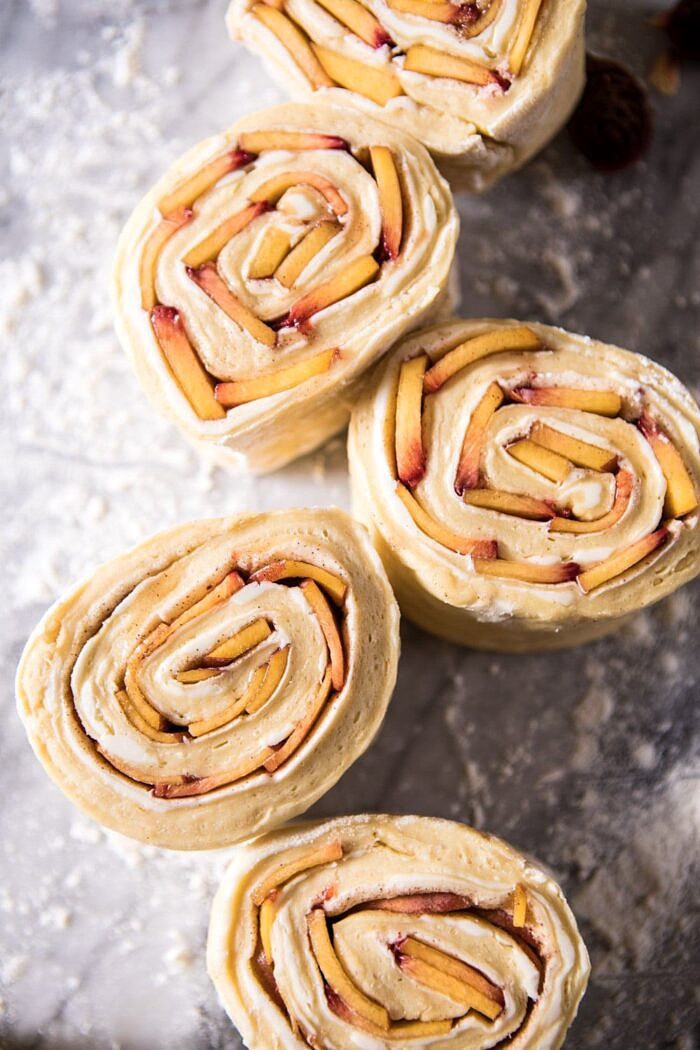 Flaky Pull Apart Cinnamon Peach Brioche rolls before baking, sliced on counter