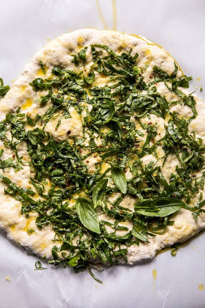 overhead photo of pizza dough with pesto