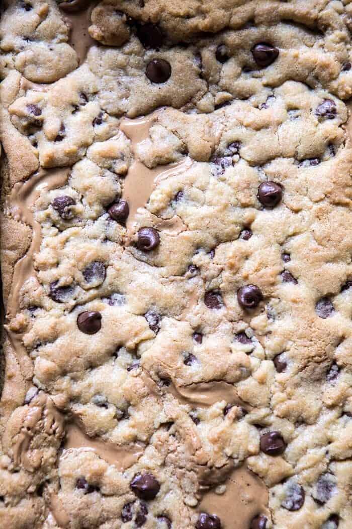 overhead photo of Chocolate Chip Peanut Butter Swirled Cookie Bars in baking pan fresh out of the oven