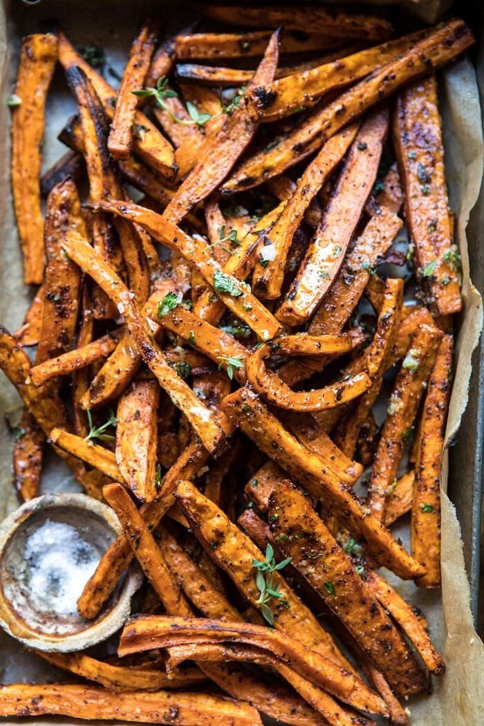 overhead close up photo of Herb Butter Baked Sweet Potato Fries in serving dish