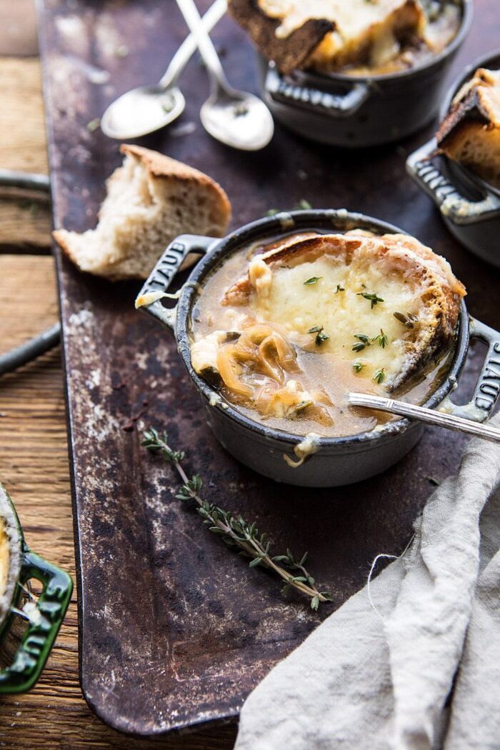 side angled photo of Herby French Shallot Soup with spoon in bowl pulling up shallots