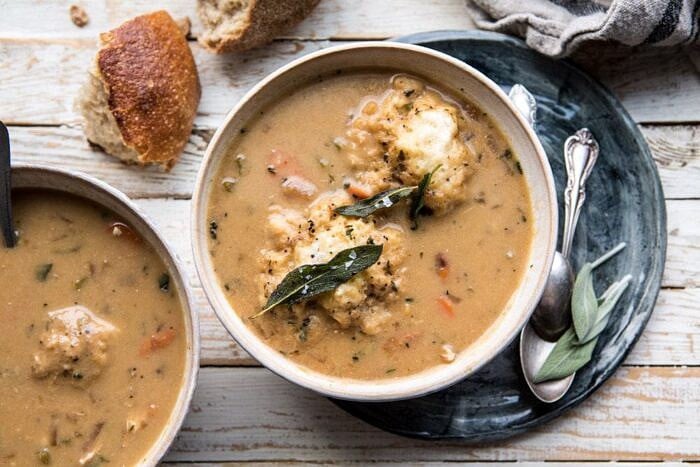 horizontal photo of One Pot Chicken and Sage Dumplings with bread on table
