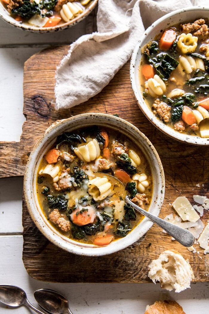 overhead photo of Spicy Italian Pesto Noodle Soup with spoon in bowl