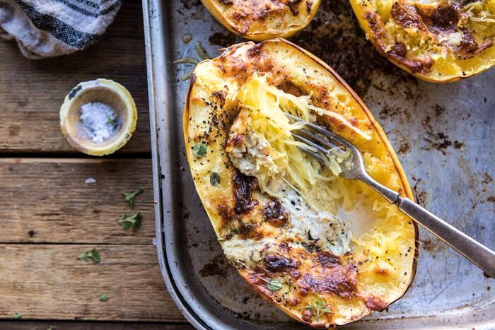 horizontal photo of Stuffed Spaghetti Squash 4 Cheese Pesto Lasagna with fork in spaghetti squash 