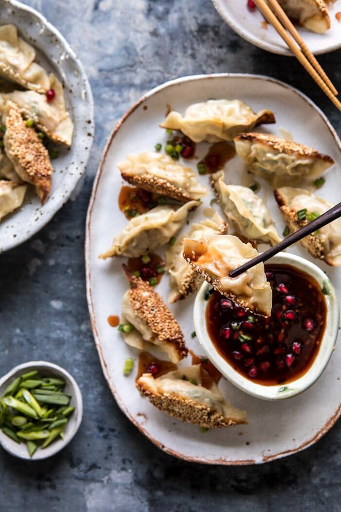 overhead photo of Ginger Sesame Chicken Potsticker being held by chopstick