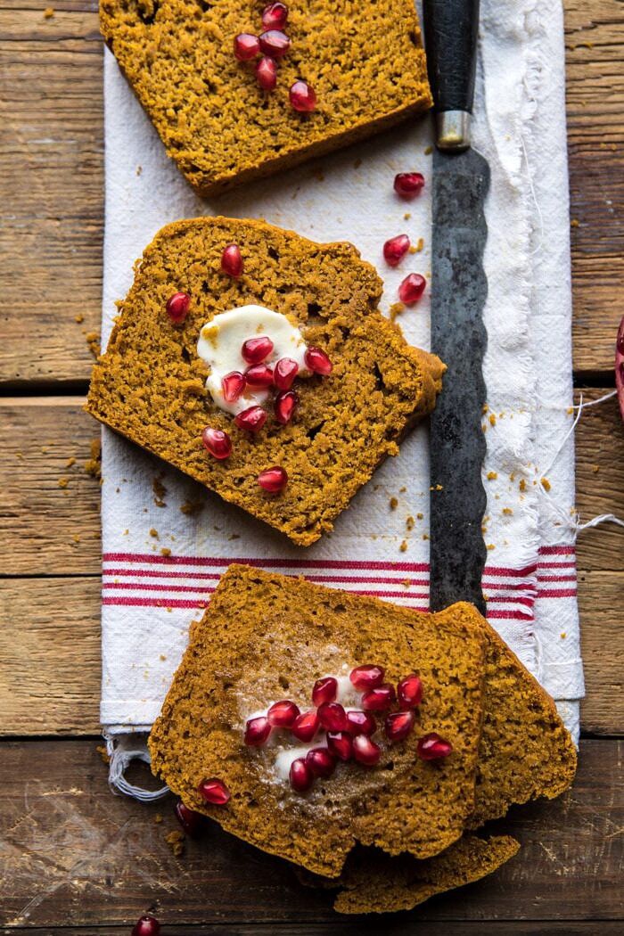 overhead photo of Healthy Pumpkin Ginger Bread slices with butter and pomegranates 