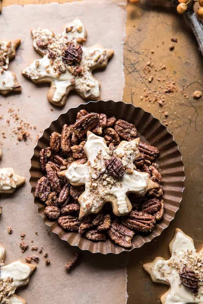 overhead photo of Pecan Pie Cookies with Butter Pecan Frosting sitting in bowl of pecans