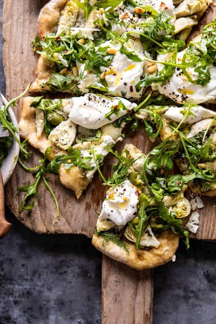 close up photo of Artichoke Pesto and Burrata Pizza with Lemony Arugula