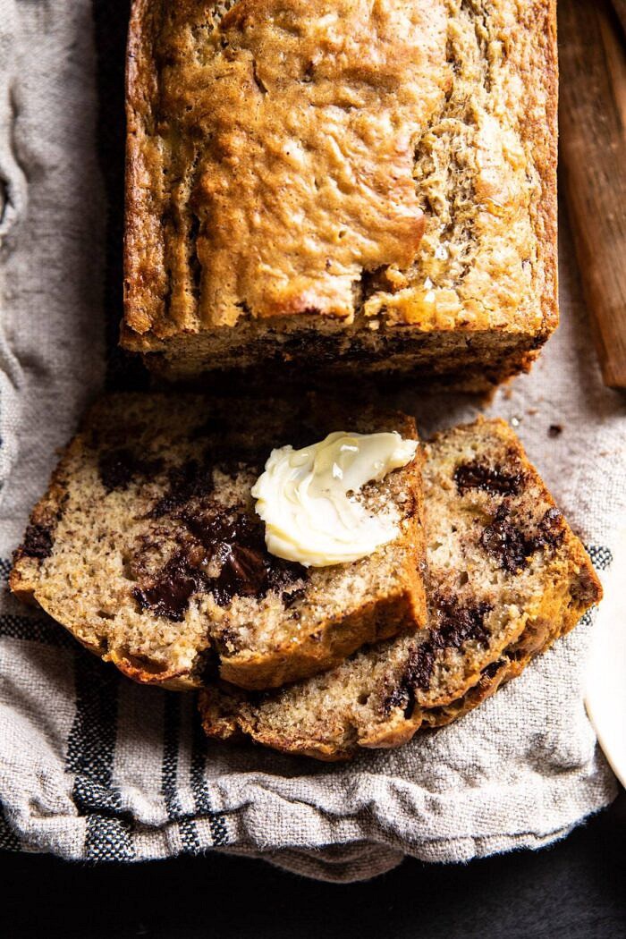 overhead close up of Chocolate Chunk Coconut Banana Bread sliced with butter