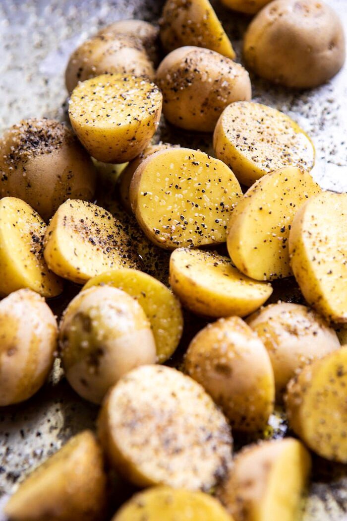 raw potatoes on baking sheet