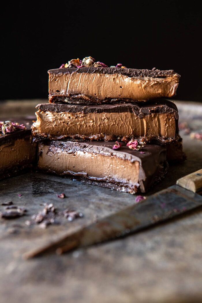 side angle photo of Vegan Triple Chocolate Mousse Cake with 3 pieces stack one on top of each other