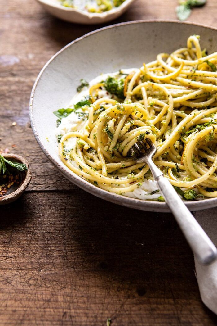 side angled photo of Broccoli Pesto Pasta with Whipped Ricotta and fork in bowl