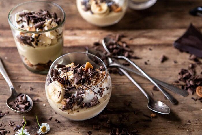 horizontal photo of Coconut Banana Cream Pie Parfaits with 2 parfaits in photo 