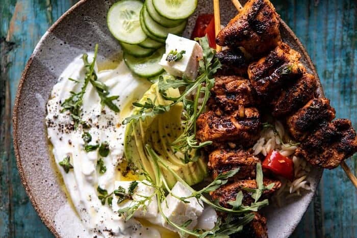 horizontal photo of Greek Lemon Chicken Bowls with Sizzled Mint Goddess Sauce