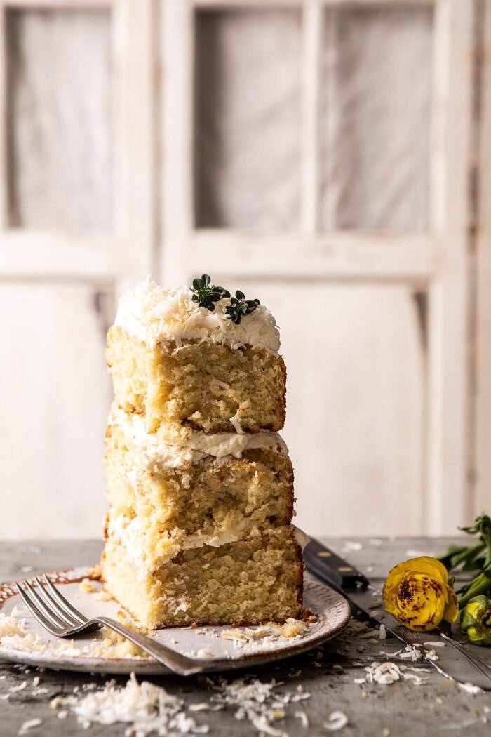 Lemon Coconut Naked Cake piece standing up on dessert plate with fork on plate