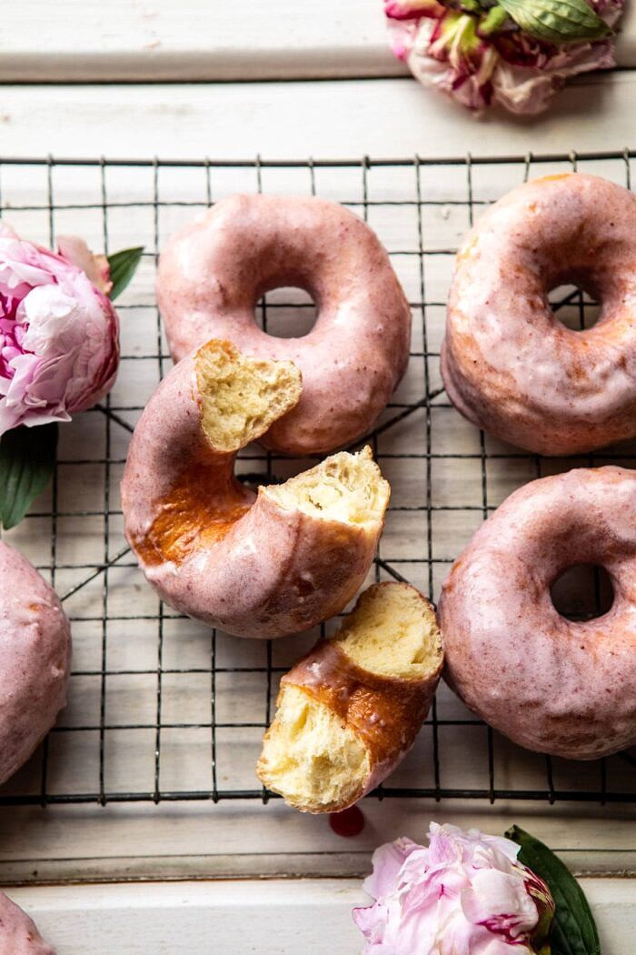 Strawberry Glazed Chai Doughnuts with bite taken out of doughnut