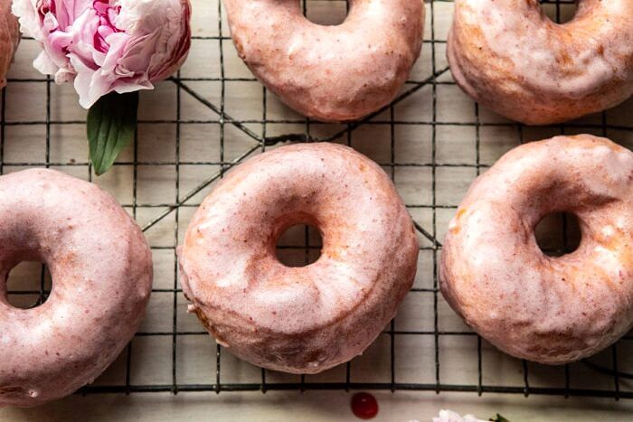 horizontal photo of Strawberry Glazed Chai Doughnuts 