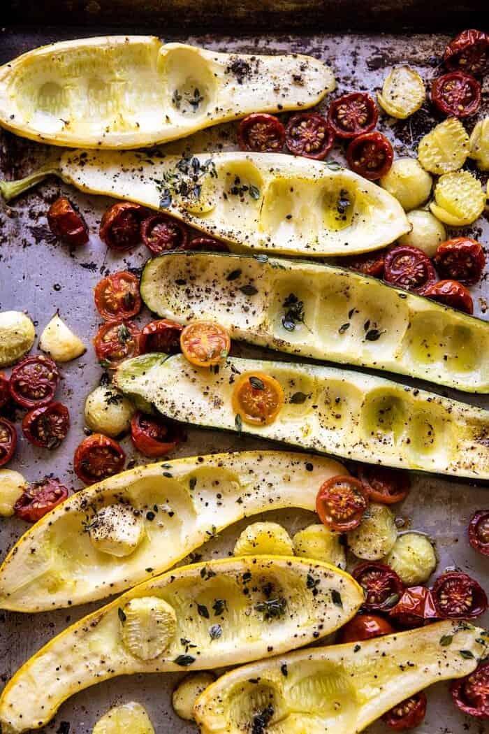 zucchini and tomatoes after roasting on baking sheet
