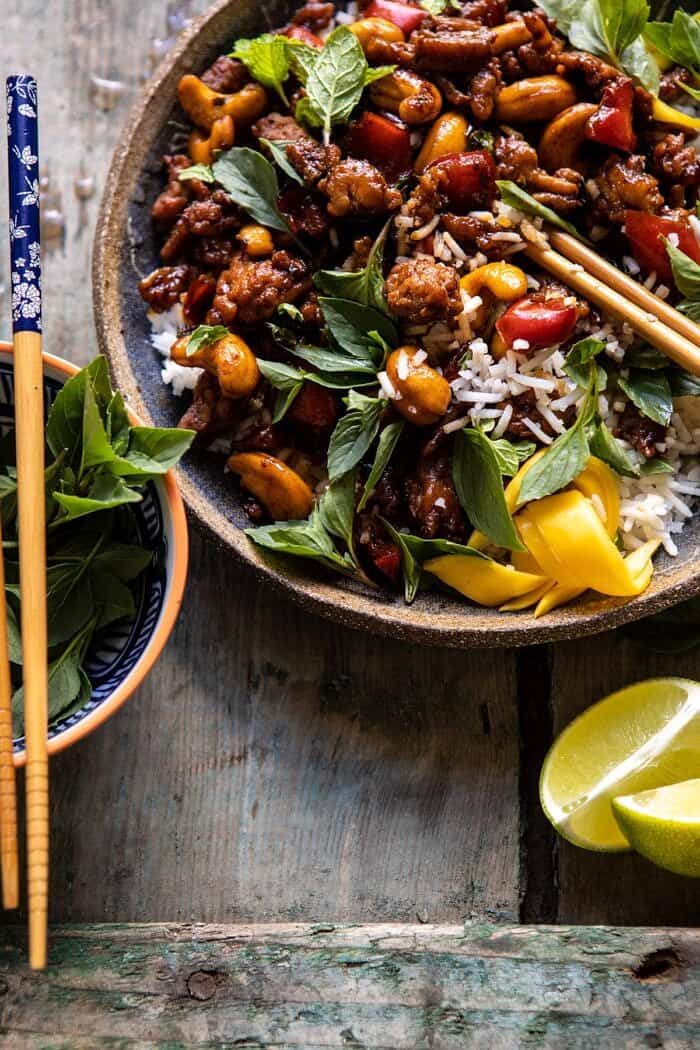 side angled close up photo of Better Than Takeout Sweet Thai Basil Chicken with chopsticks in photo 