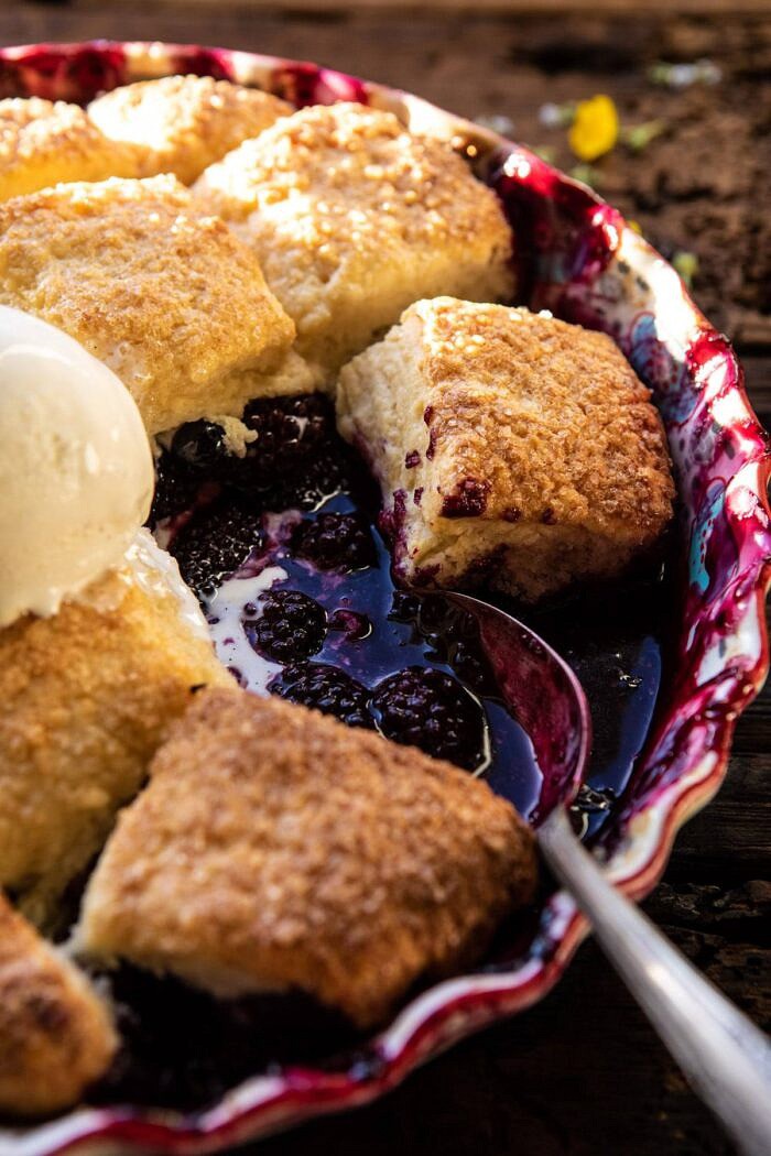 close up side angled photo of Blackberry Lavender Cobbler with serving spoon in baking dish 