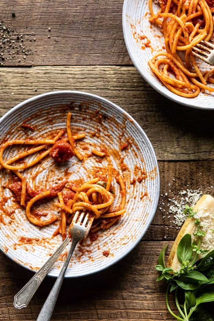 overhead photo of empty bowl of Bucatini Amatriciana with fork in pasta 