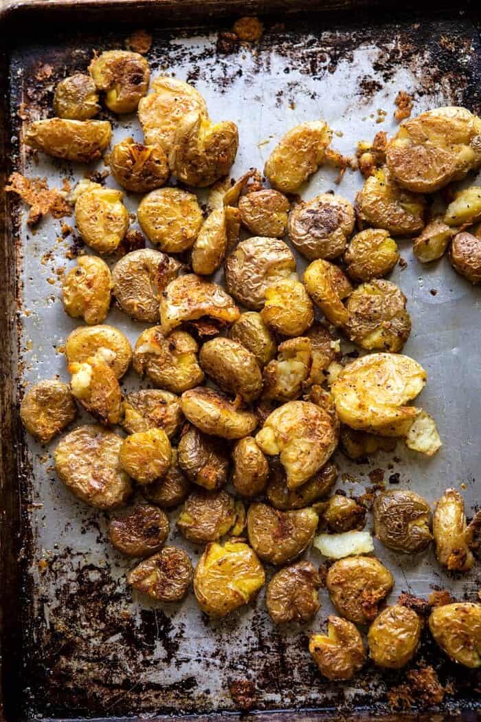 overhead photo of Crispy Salt and Vinegar Smashed Potatoes on baking sheet after roasting