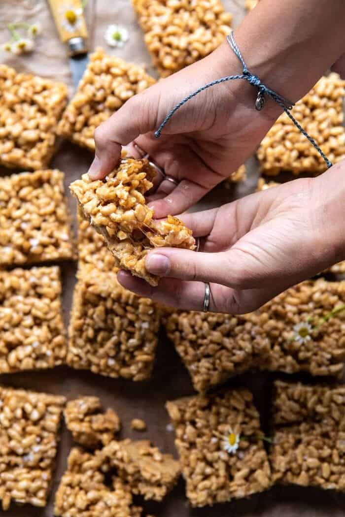 overhead photo of Better Than Mom's Brown Butter Rice Krispie Treats being pulled apart to show their sticky marshmallow center