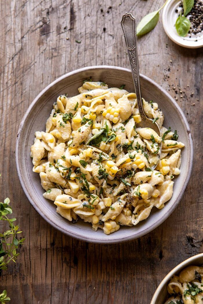 overhead photo of One Pot Lemon Basil, Corn, and Ricotta Pasta in single serving bowl with spoon in bowl 