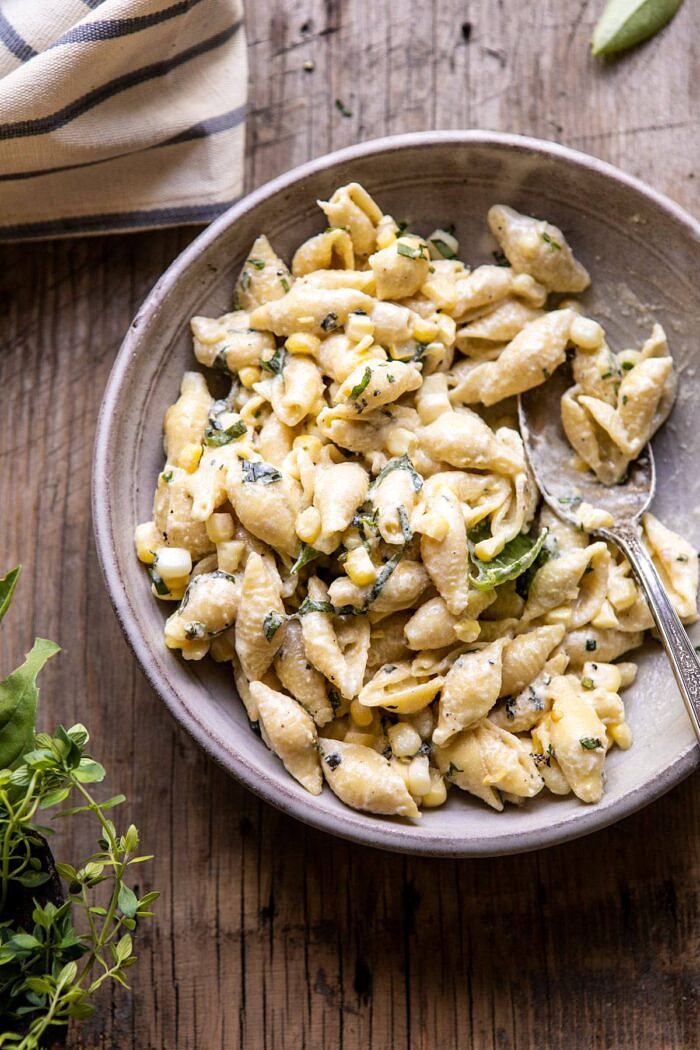 overhead photo of One Pot Lemon Basil, Corn, and Ricotta Pasta in single serving bowl with spoon in bowl