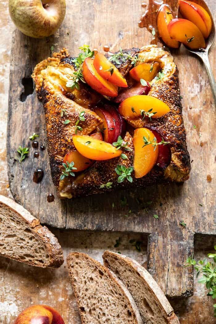 Pastry Wrapped Baked Brie with Thyme Butter Roasted Plums before cutting into