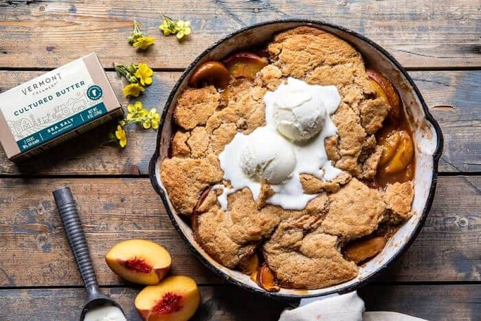 horizontal photo of Skillet Brown Sugar Peach Cobbler | halfbakedharvest.com #peach #summer #easyrecipes #cobbler