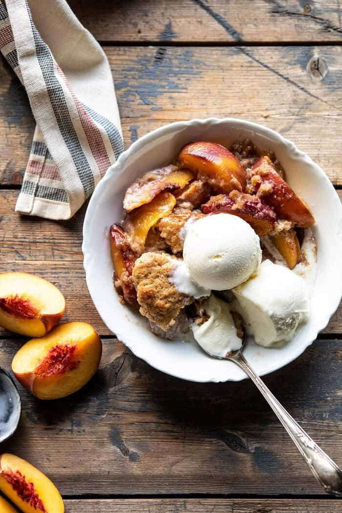 overhead photo of Skillet Brown Sugar Peach Cobbler in single serving dish with spoon in dish