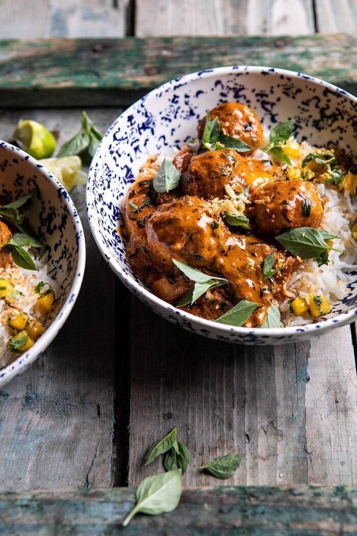 side angled photo of Weeknight 30 Minute Coconut Curry Chicken Meatballs in bowls with rice