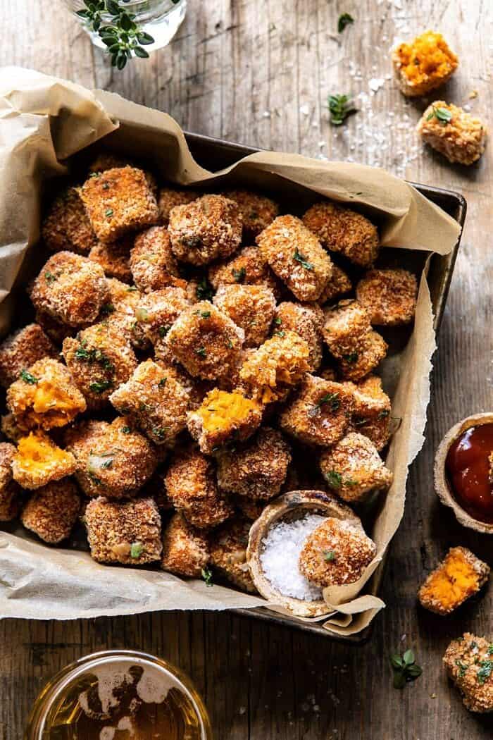 overhead close up photo of Baked Sweet Potato Parmesan Tater Tots with tot broken in half 