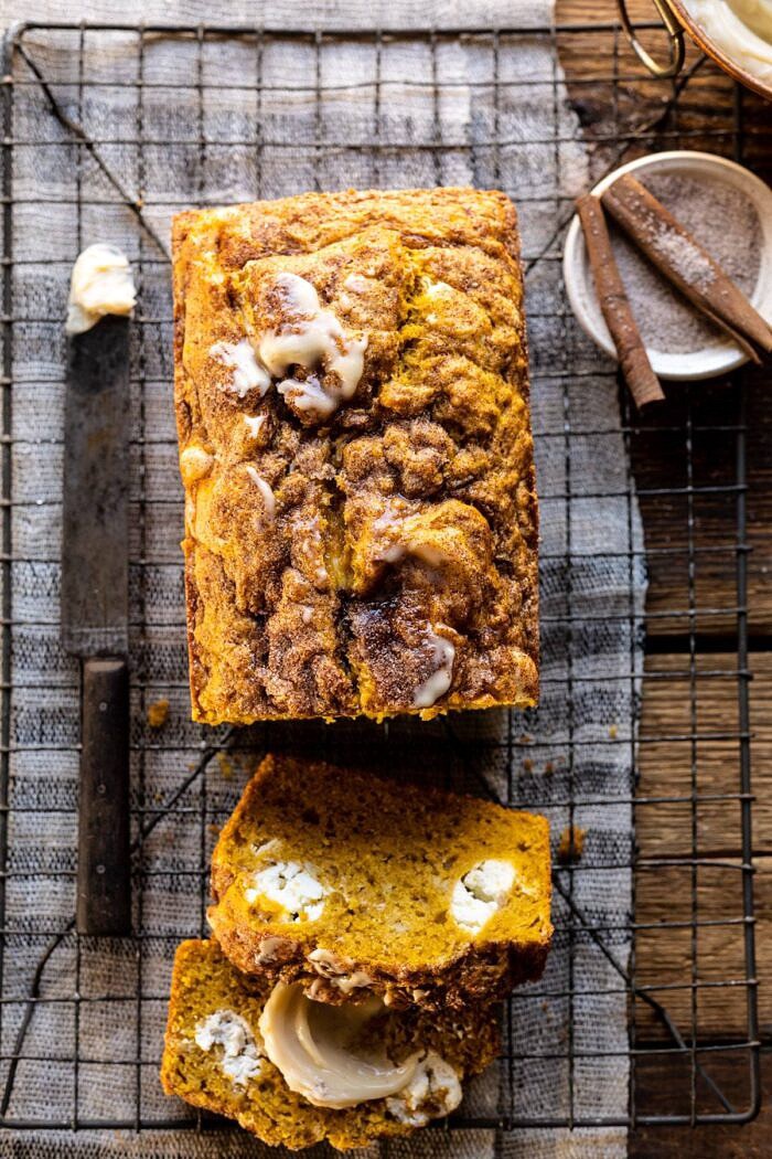 overhead close up photo of Cream Cheese Swirled Pumpkin Bread with 2 slices of bread cut