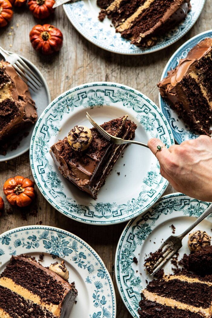 overhead photo of Pumpkin Patch Chocolate Peanut Butter Cake slices with fork going into cake and hand in photo 