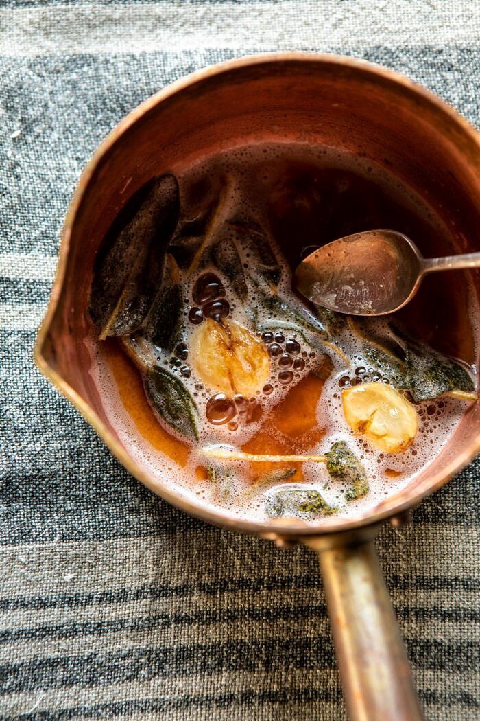 overhead photo of browned butter with sage and garlic in small saucepan 