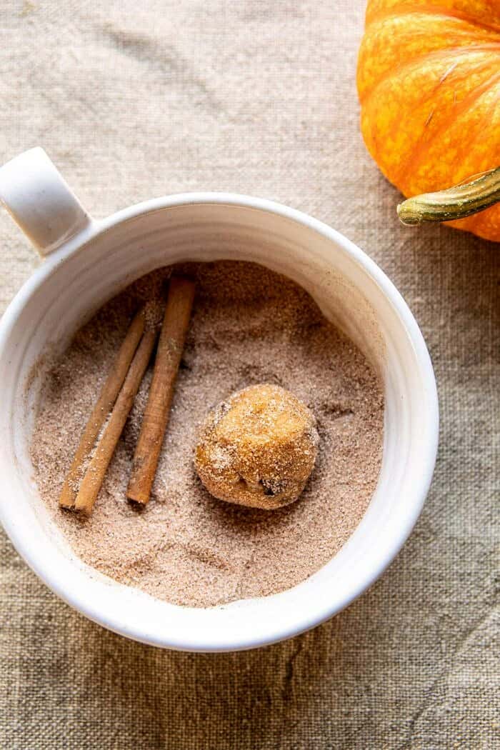 Pumpkin Butter Chocolate Chip Cookie dough ball sitting in cinnamon sugar