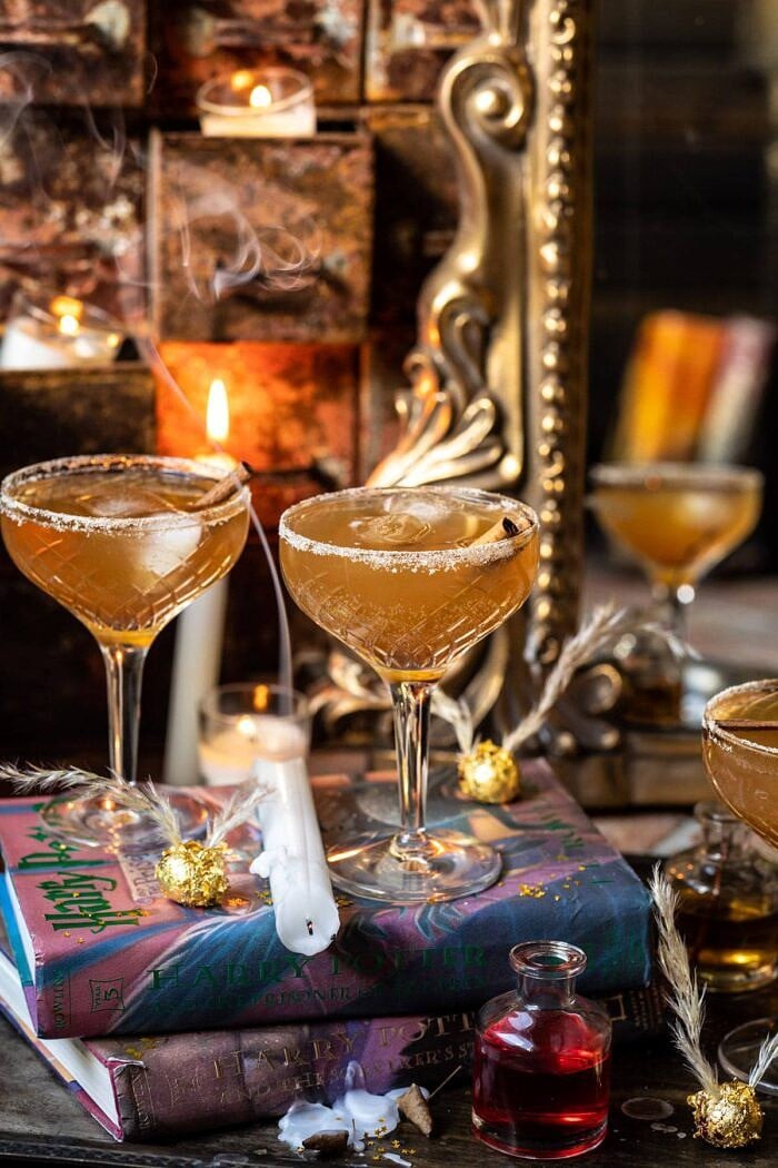 front on photo of The Golden Snitch Cocktail with candle blown out and smoking