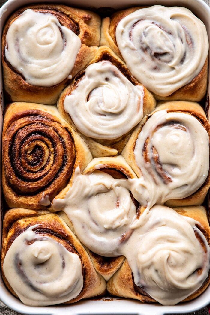overhead close up photo of Easy Gingerbread Brioche Cinnamon Rolls in baking dish