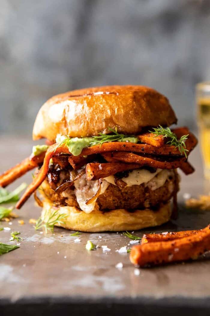 Crispy Quinoa Burgers Topped with Sweet Potato Fries and Beer Caramelized Onions | halfbakedharvest.com #quinoaburger