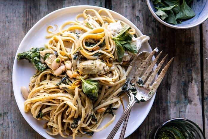 horizontal photo of One Pot Creamy Tuscan Pesto and Artichoke Pasta on serving plate 