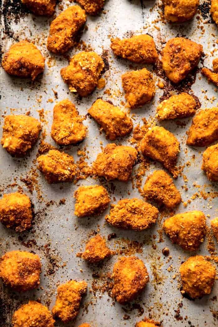 overhead photo of Oven Fried Cajun Popcorn Chicken on baking sheet