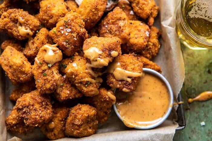 horizontal photo of Oven Fried Cajun Popcorn Chicken with Creamy Honey Mustard 