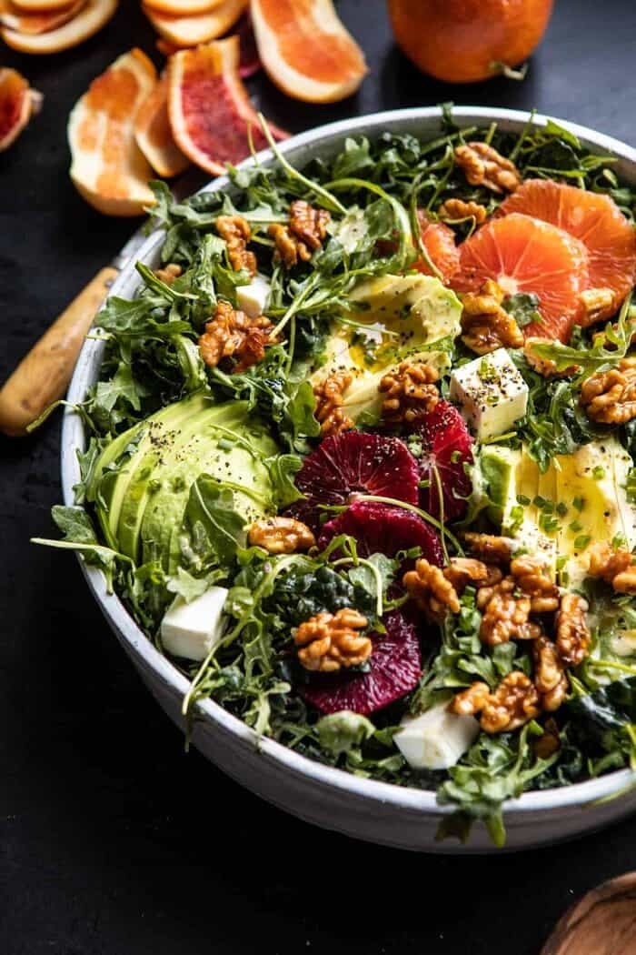 side angled close up photo of Citrus Avocado Salad with Orange Tahini Vinaigrette