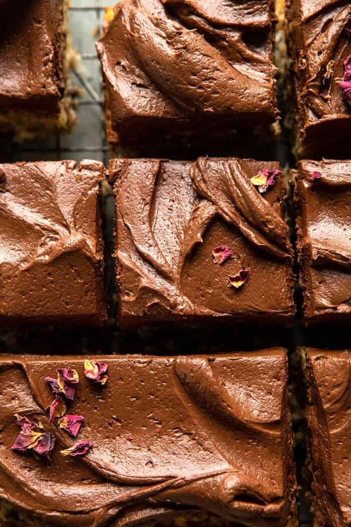 overhead close up photo of Easiest Coconut Banana Cake with Fudgy Chocolate Frosting and squares of cake cut 